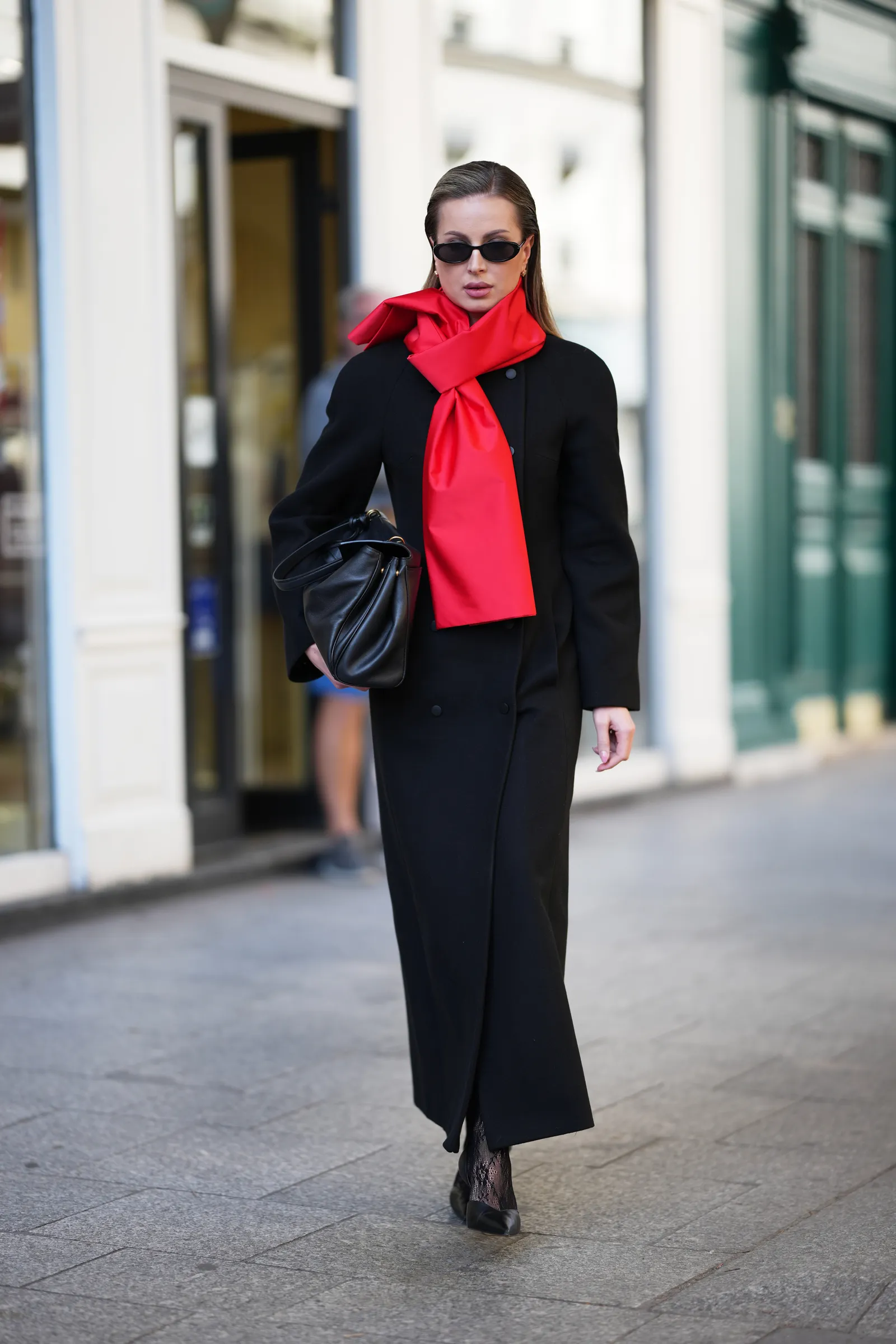 Image may contain Clothing Coat Formal Wear Suit Scarf Person Accessories Bag Handbag Face and Head
