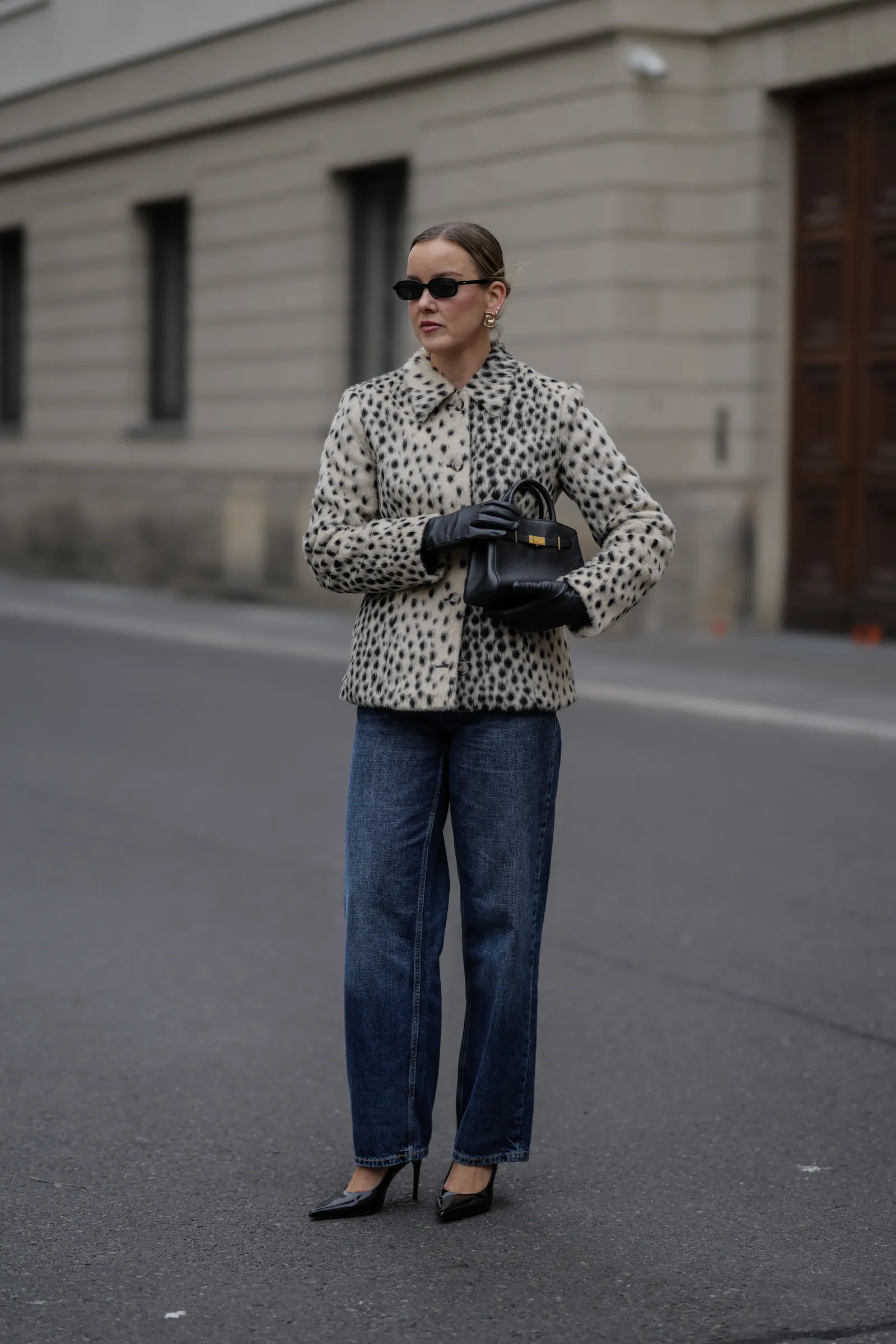 Image may contain Clothing Pants Jeans Glove Adult Person Accessories Bag Handbag Glasses and Coat
