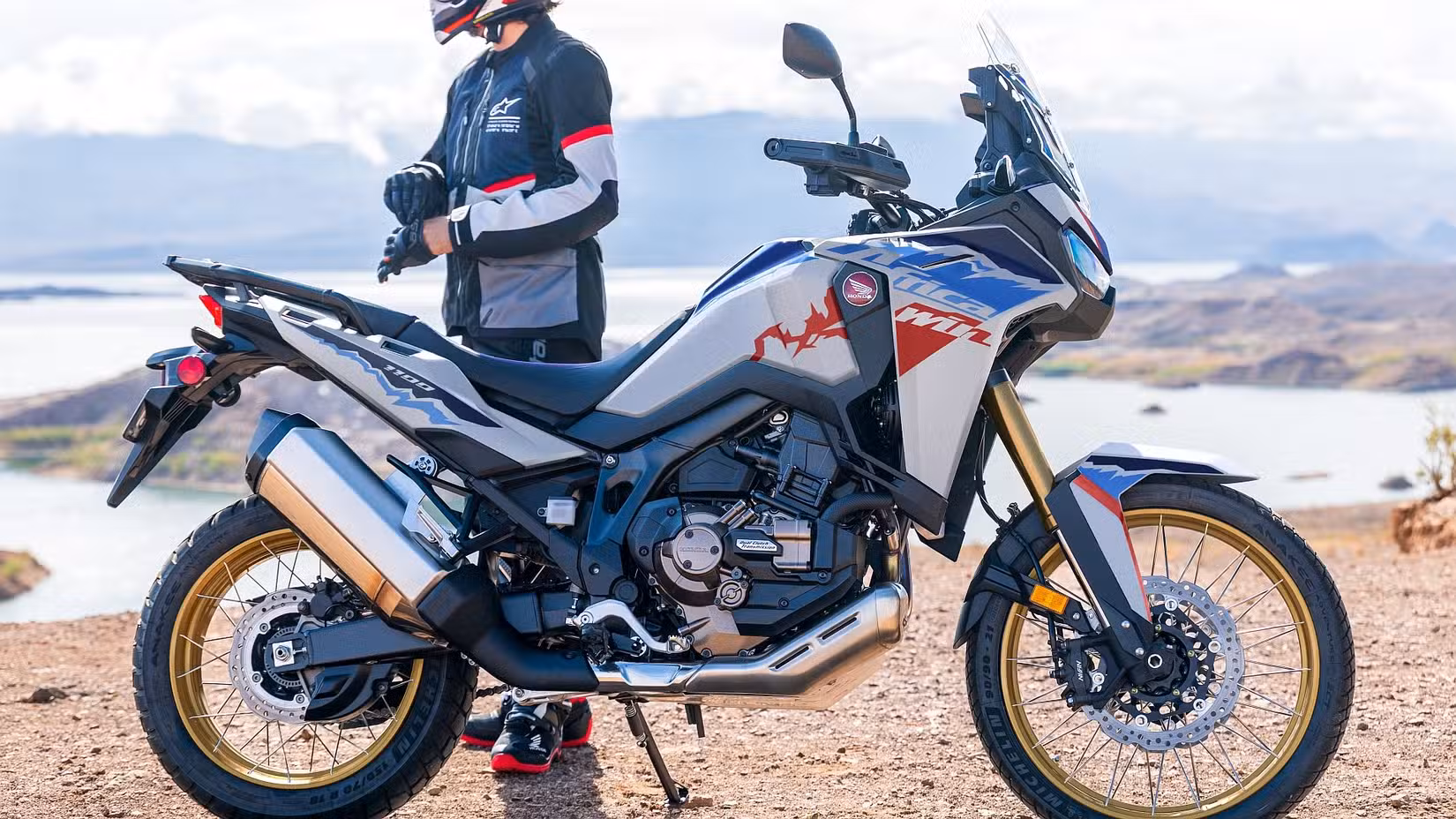 Side shot of a 2026 Honda Africa Twin parked off-road in front of rider