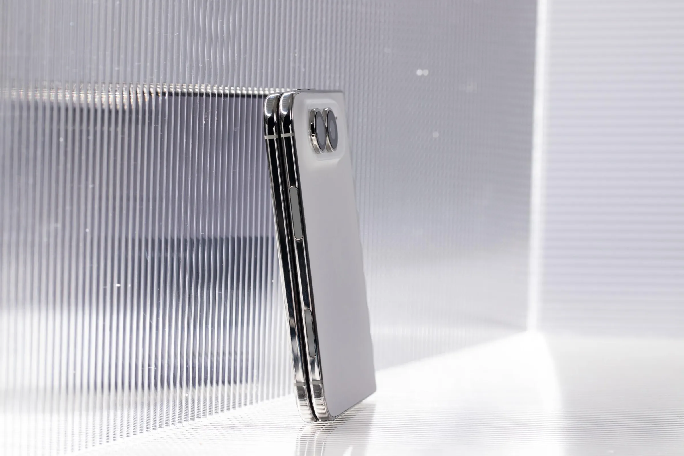 A white iPhone Duo when closed, pictured from the side so you can see the back of the phone.