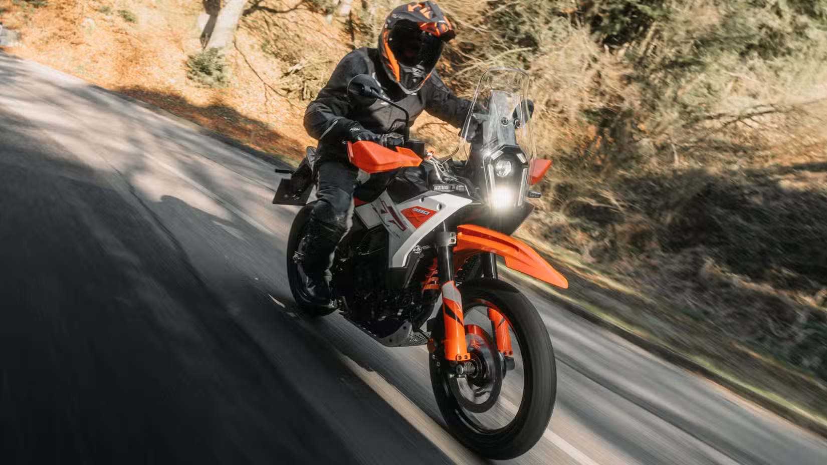 2026 KTM 390 Adventure X cornering fast on tarmac front third quarter cinematic shot