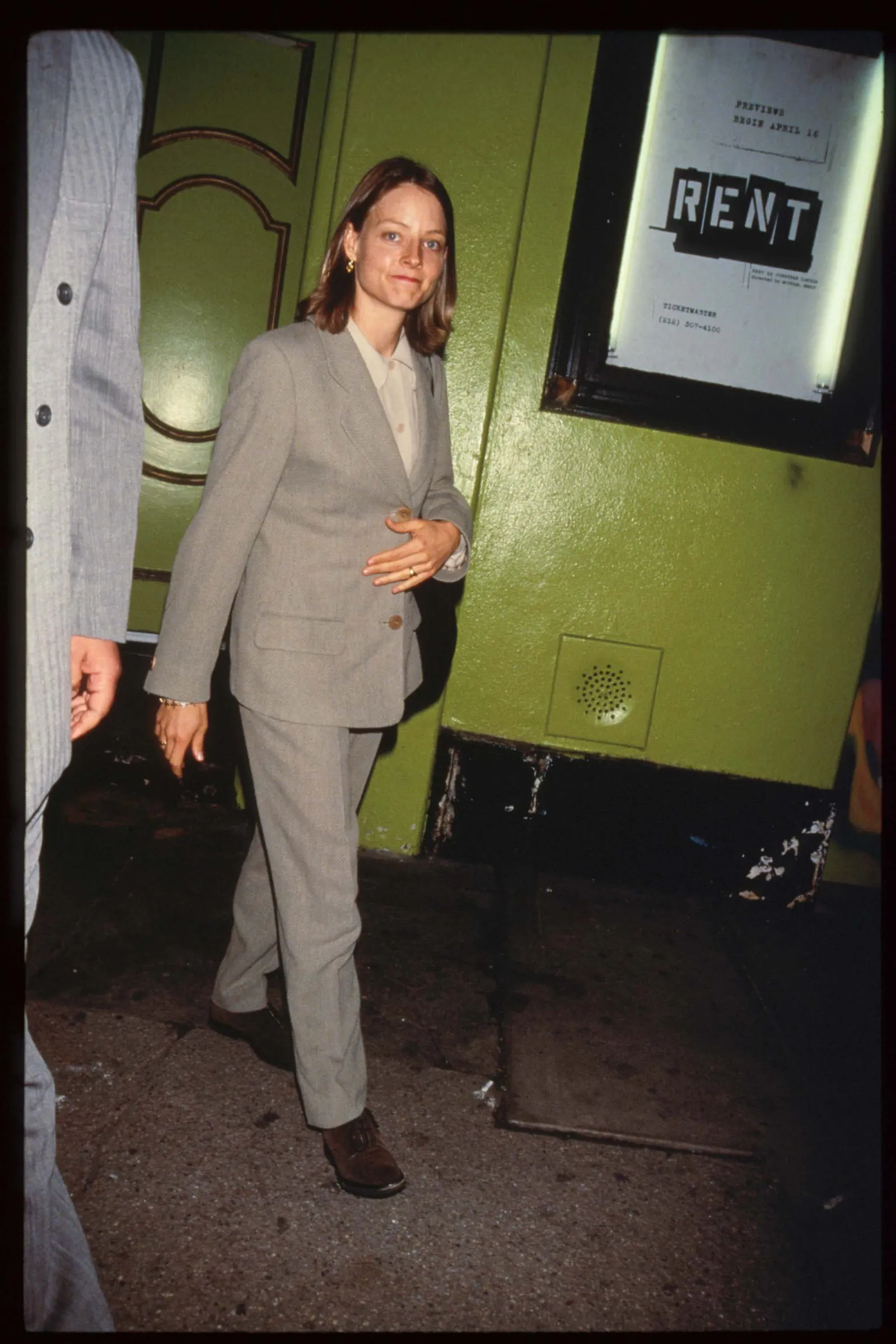 Image may contain Jodie Foster Clothing Formal Wear Suit Blazer Coat Jacket Person Photobombing Adult and Standing