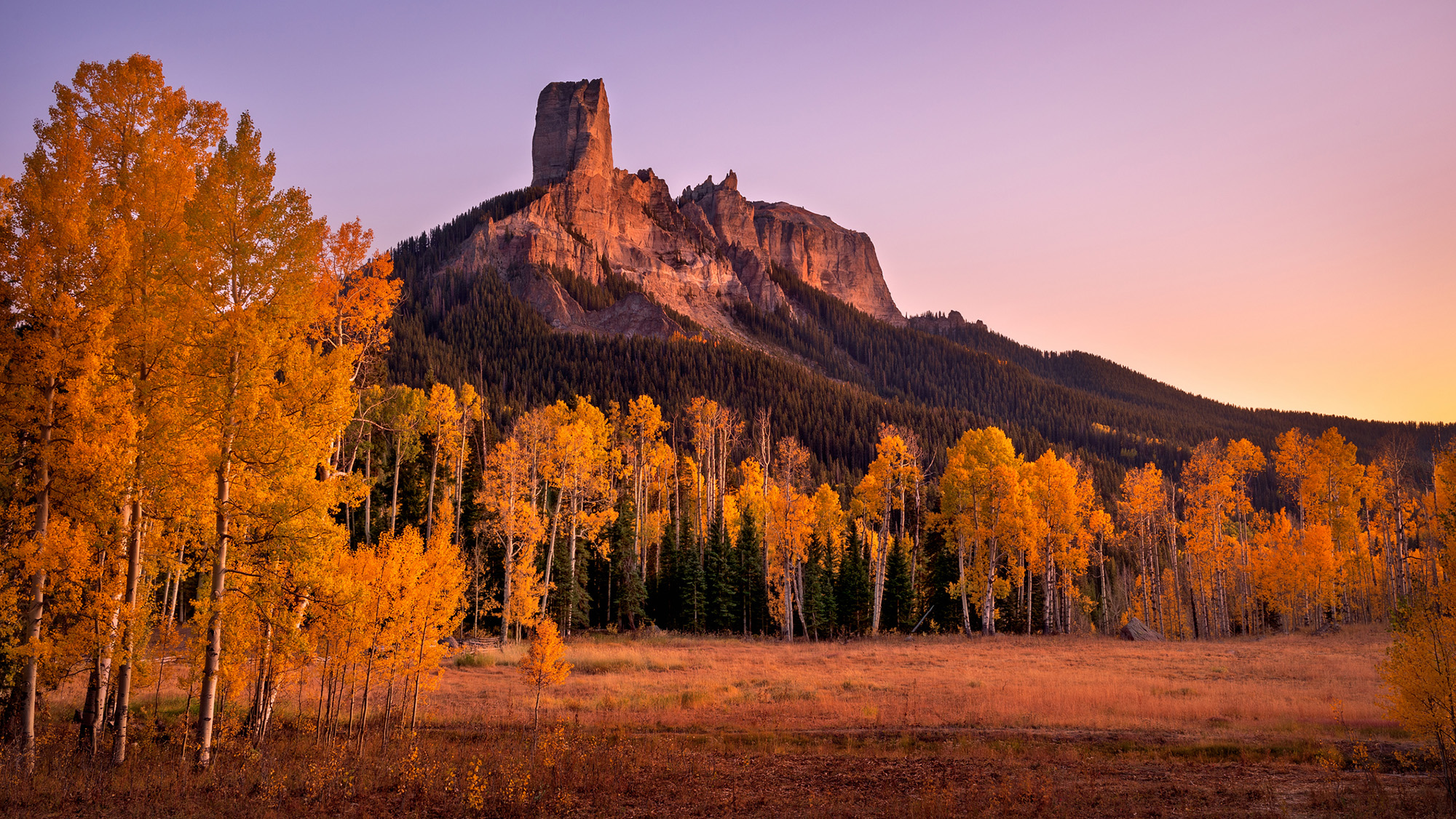 A tall rocky peak on a hill.