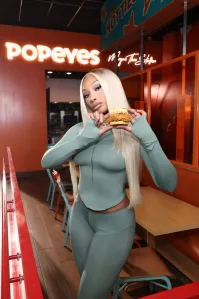 MIAMI BEACH, FLORIDA - OCTOBER 06: Megan Thee Stallion Stops By Her Miami Popeyes To Enjoy Her New Go-To Order: Popeyes New Honey Chicken Biscuit Sandwich on October 06, 2026 in Miami Beach, Florida. (Photo by Alexander Tamargo/Getty Images for Popeyes)