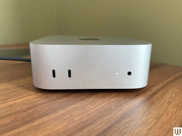 Front view of Apple Mac Mini M4 2024, a silver square shaped computer with small ports in the front