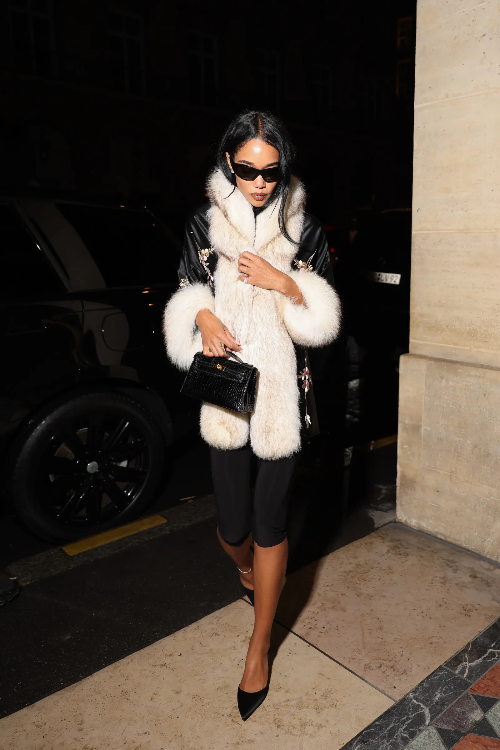 Image may contain Laura Harrier Adult Person Accessories Bag Handbag Clothing Coat Machine Wheel and Jacket