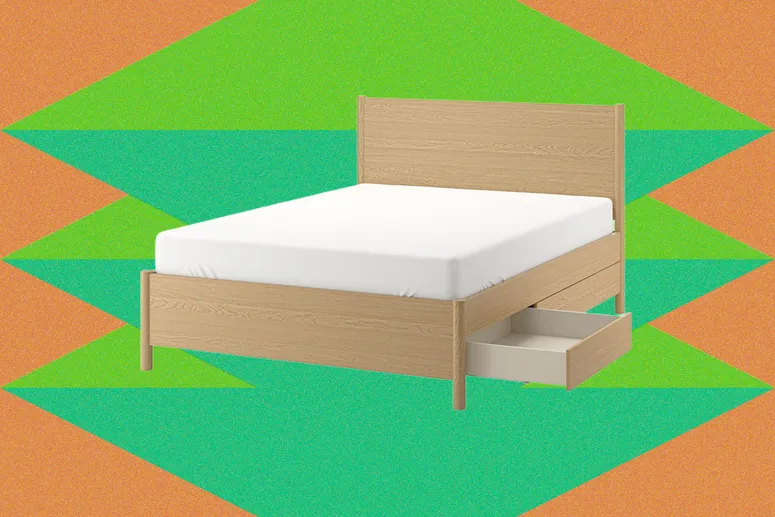 Beige wooden bed frame with an open drawer underneath and white mattress on top