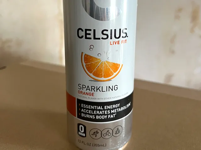 White and silver aluminum can with an orange slice and sparkling bubbles as part of the design