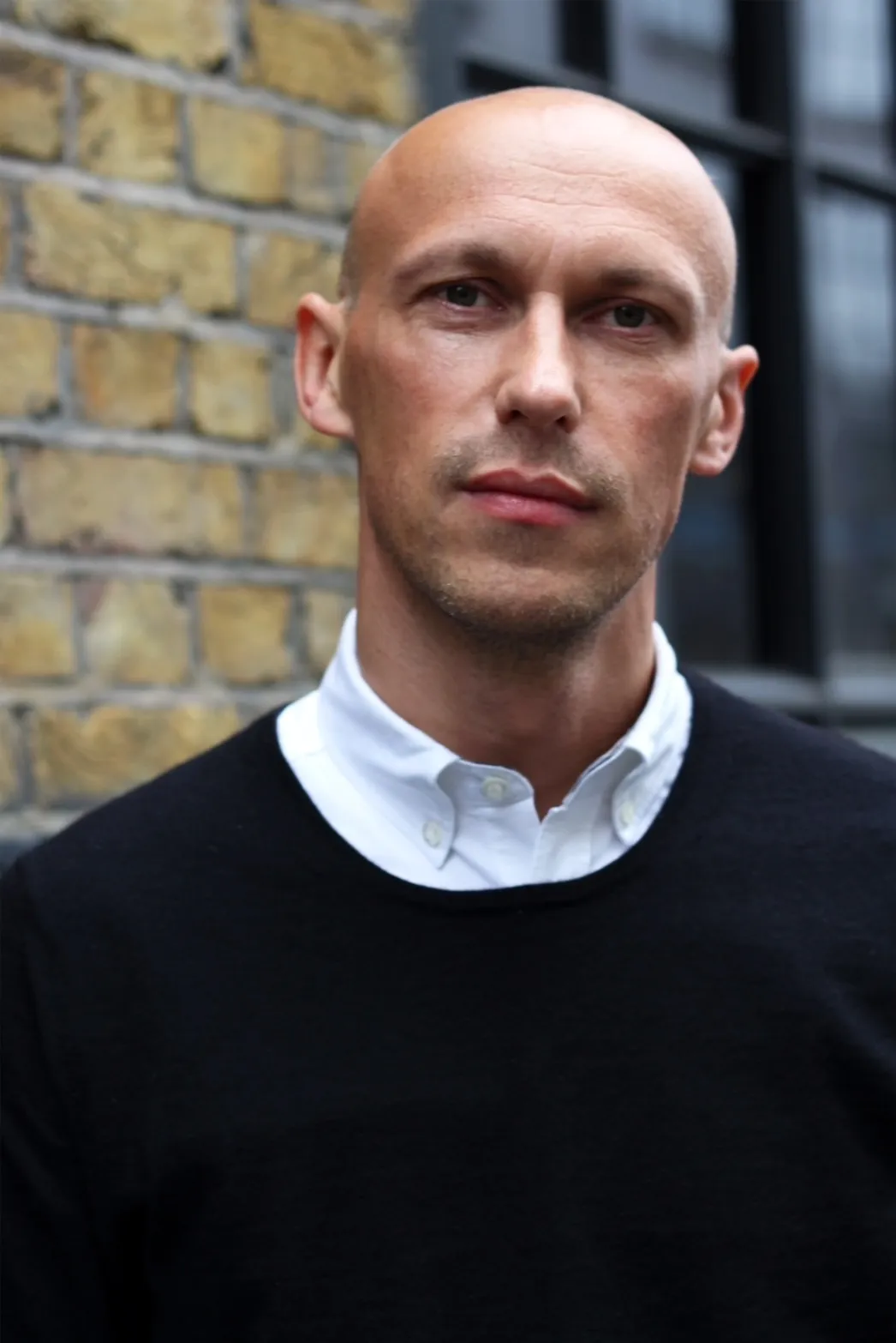 Image may contain Face Head Person Photography Portrait Body Part Neck Adult Blonde Hair and Crew Cut
