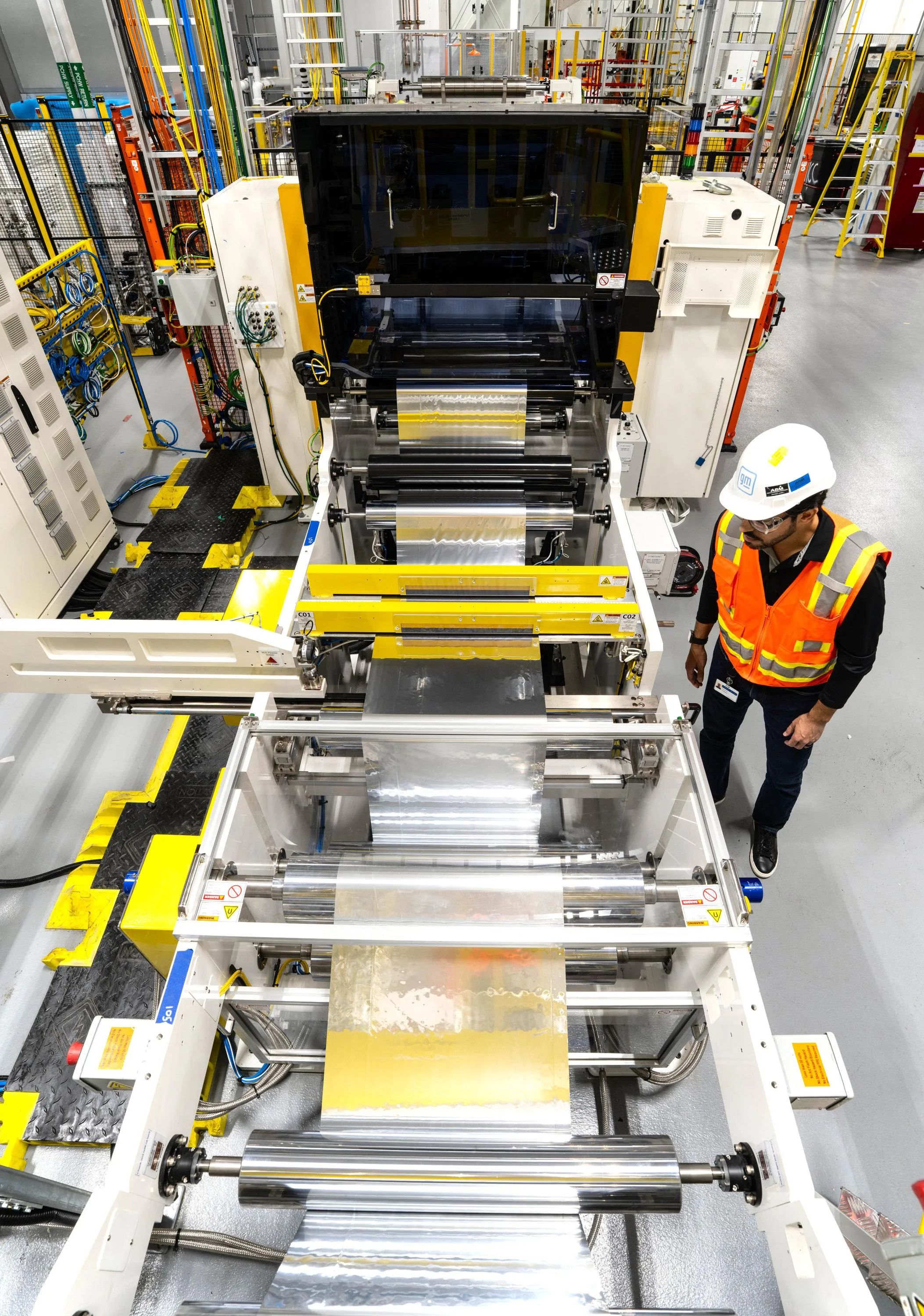 An engineer inspects a roll press system at GM’s new Battery Cell Development Center.