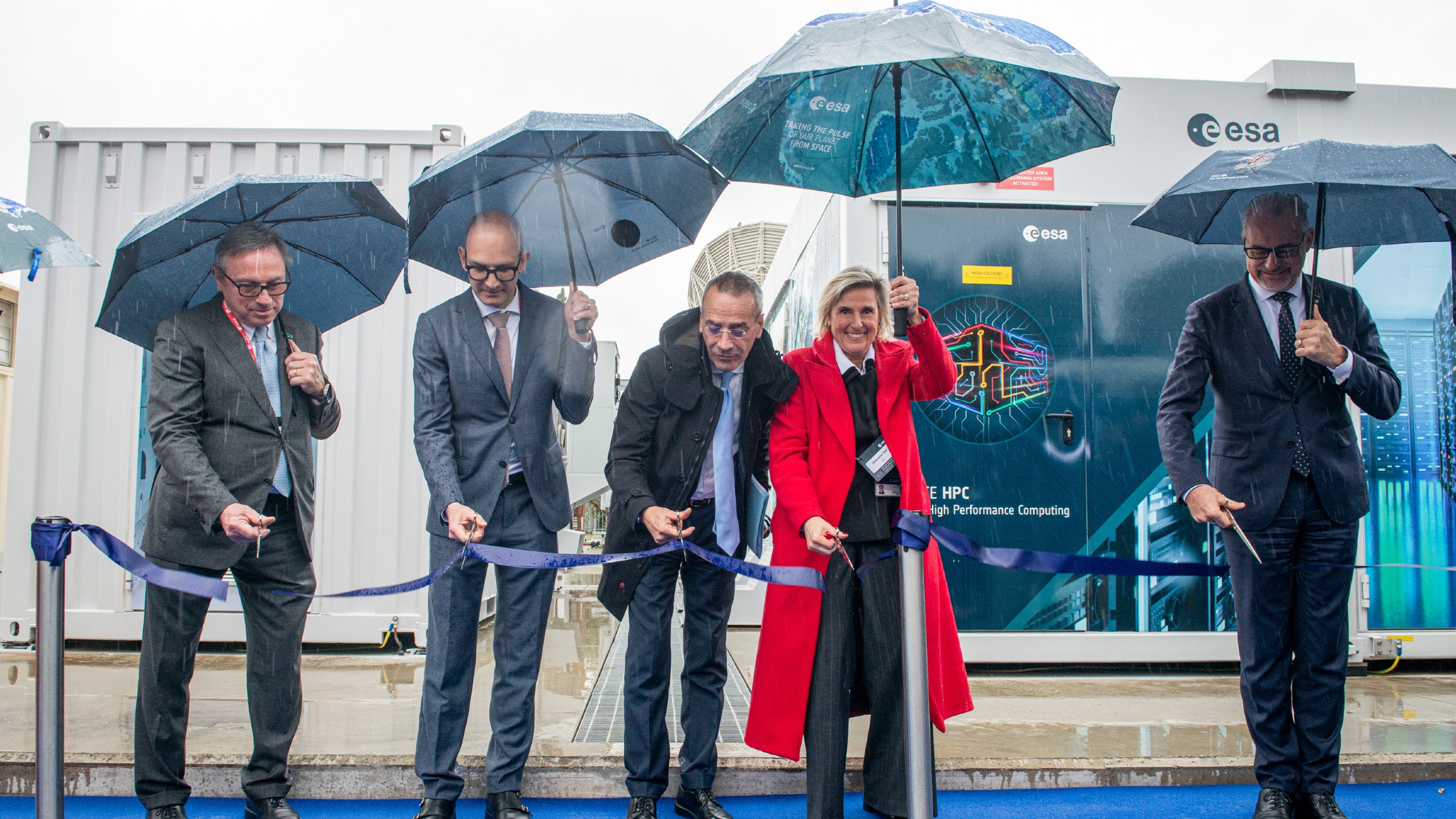 A photo of Simonetta Chelli (red coat) stood next to other ESA officials at the opening of the Space HPC supercomputer in Frascati