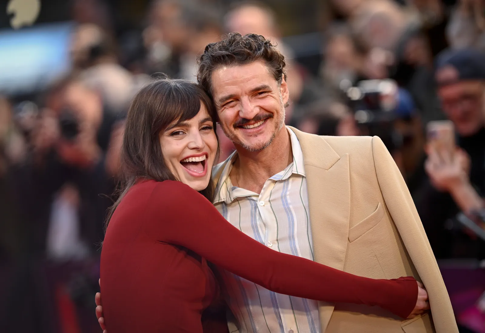 Image may contain Pedro Pascal Head Person Face Happy Laughing Adult and Smile