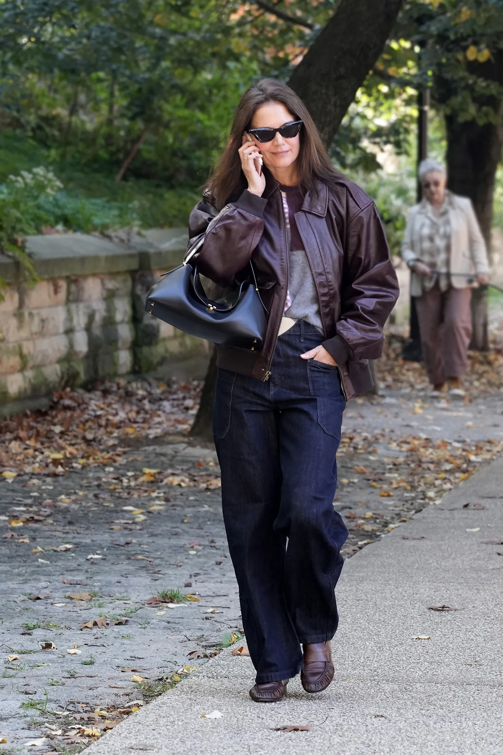 Image may contain Katie Holmes Clothing Pants Coat Jacket Jeans Adult Person Accessories Bag and Handbag