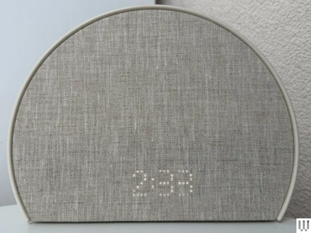 Semi-circular clock with fabric front cover