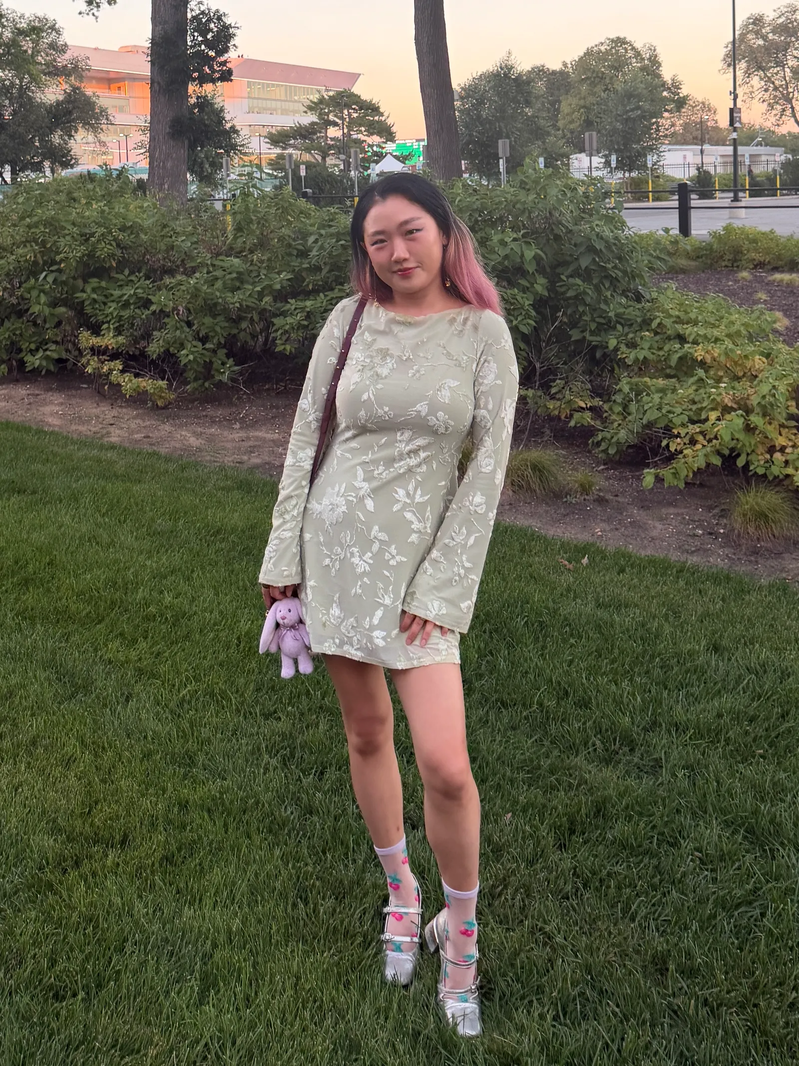 A front view of Allure commerce editor Sarah Han wearing the Sticky Cakes Lift underneath a green dress