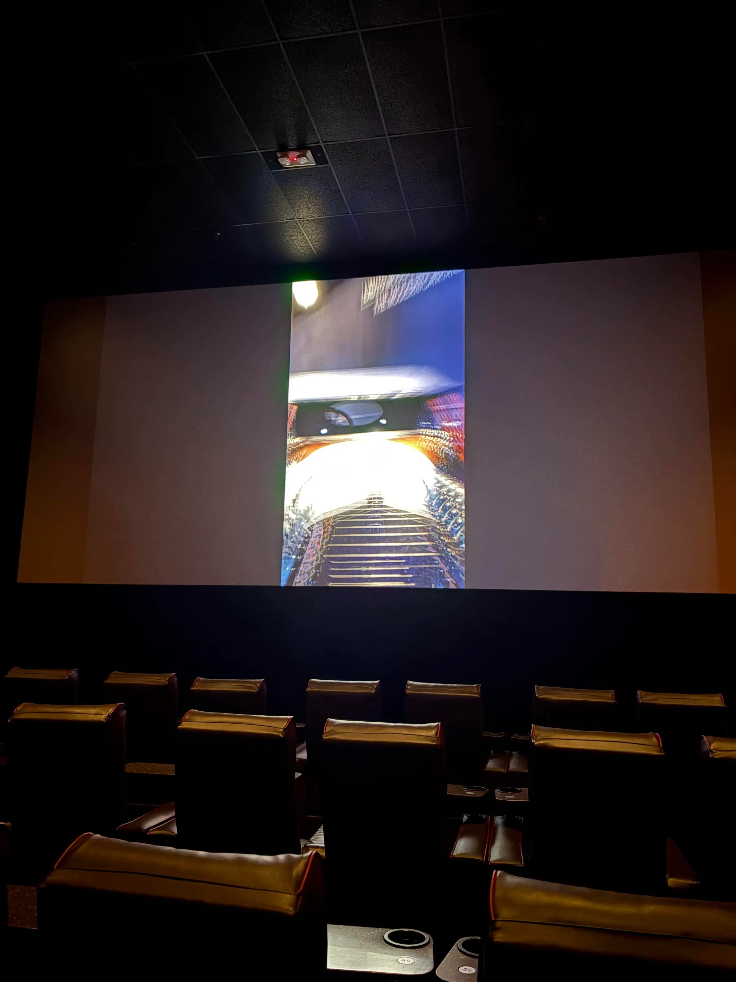A photo of a vertical microdrama being projected on a movie theater screen.