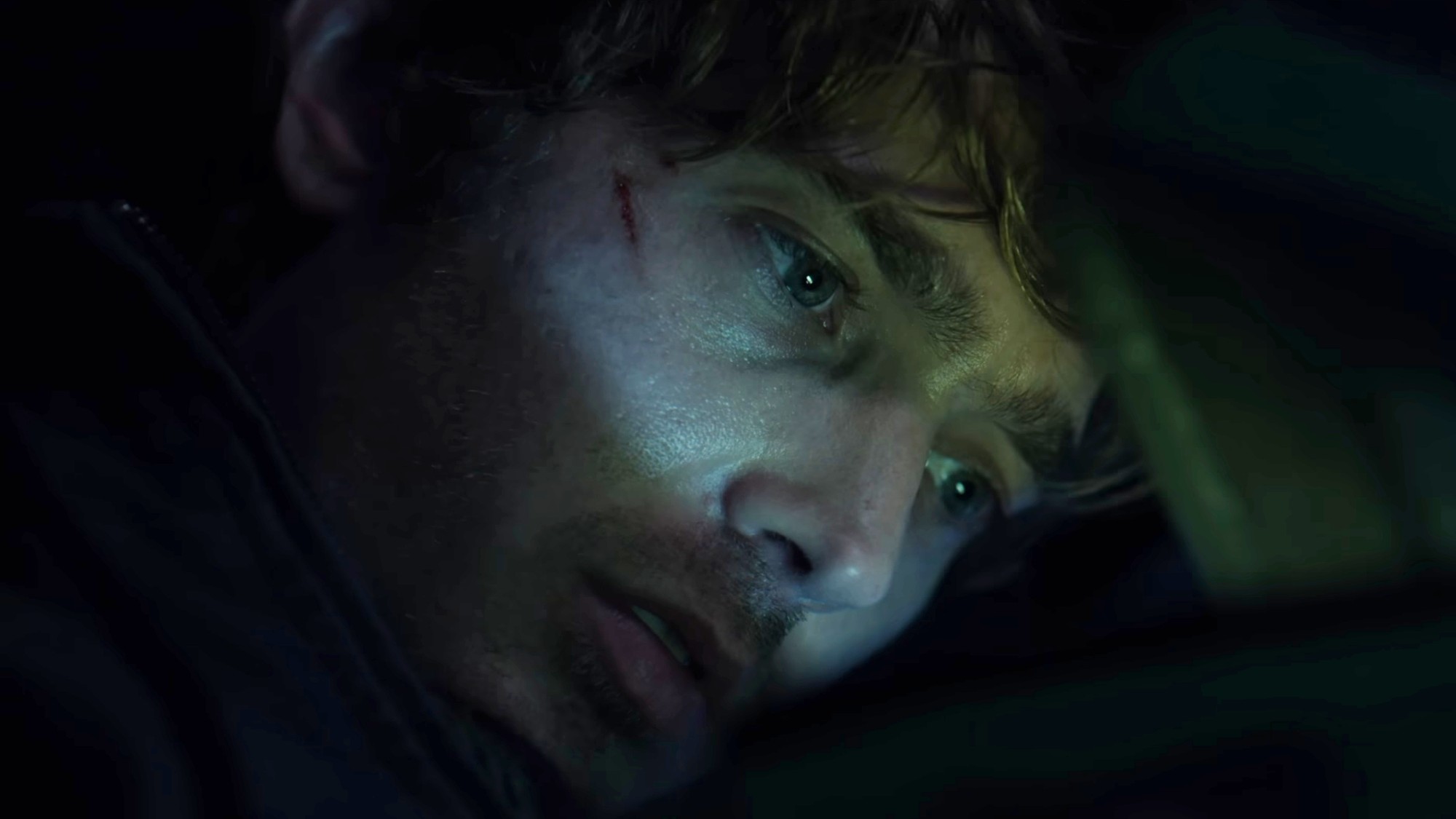 Austin Abrams looking at the antidote in Resident Evil.