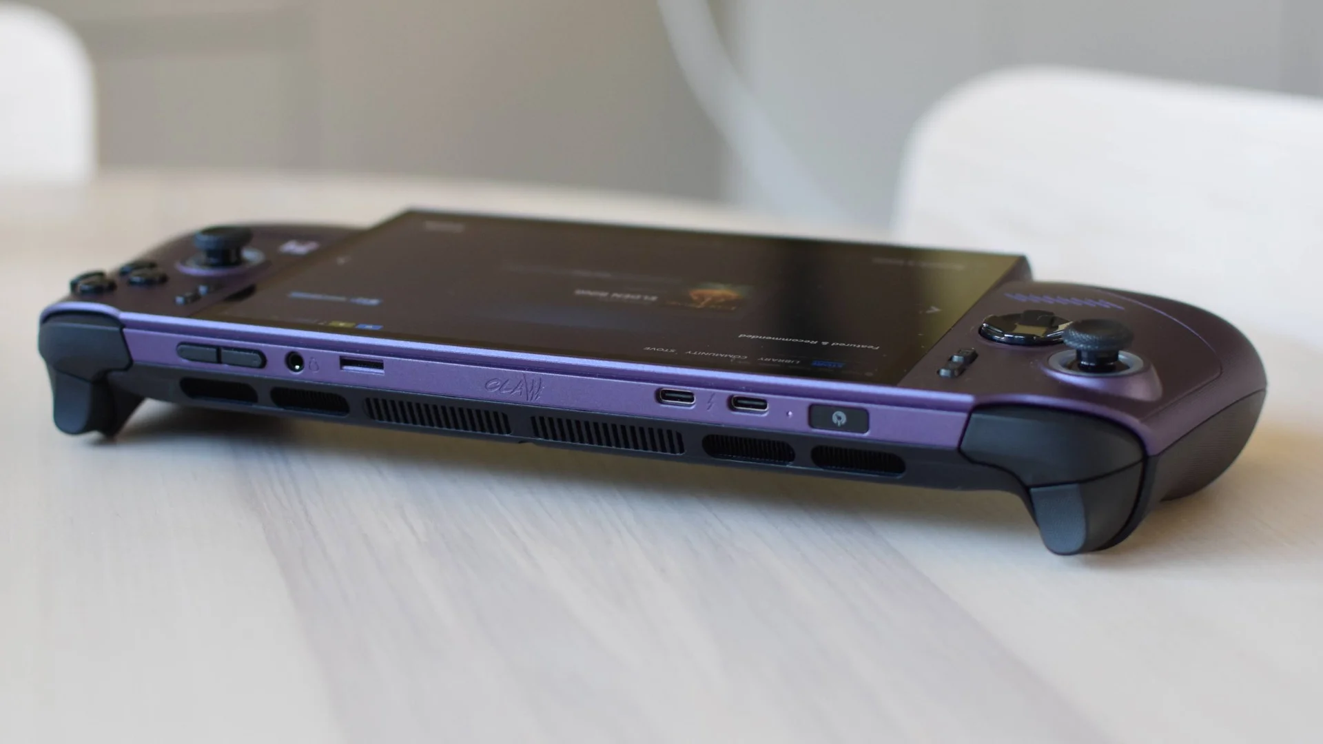 An MSI Claw 8 EX AI+ on a table, with the camera facing its top edge.