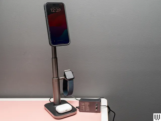 Mophie MagSafe 3-in-1 Extendable Wireless Charging Stand , a slender stand with square base, circular pad on top to hold a phone, and small extension on the side to hang a wristwatch.