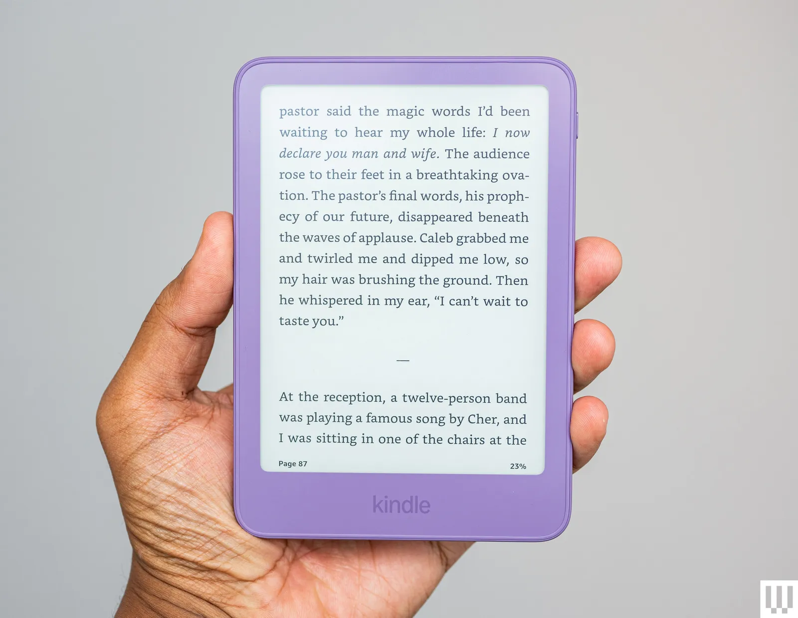 Hand holding a slim purple ereader