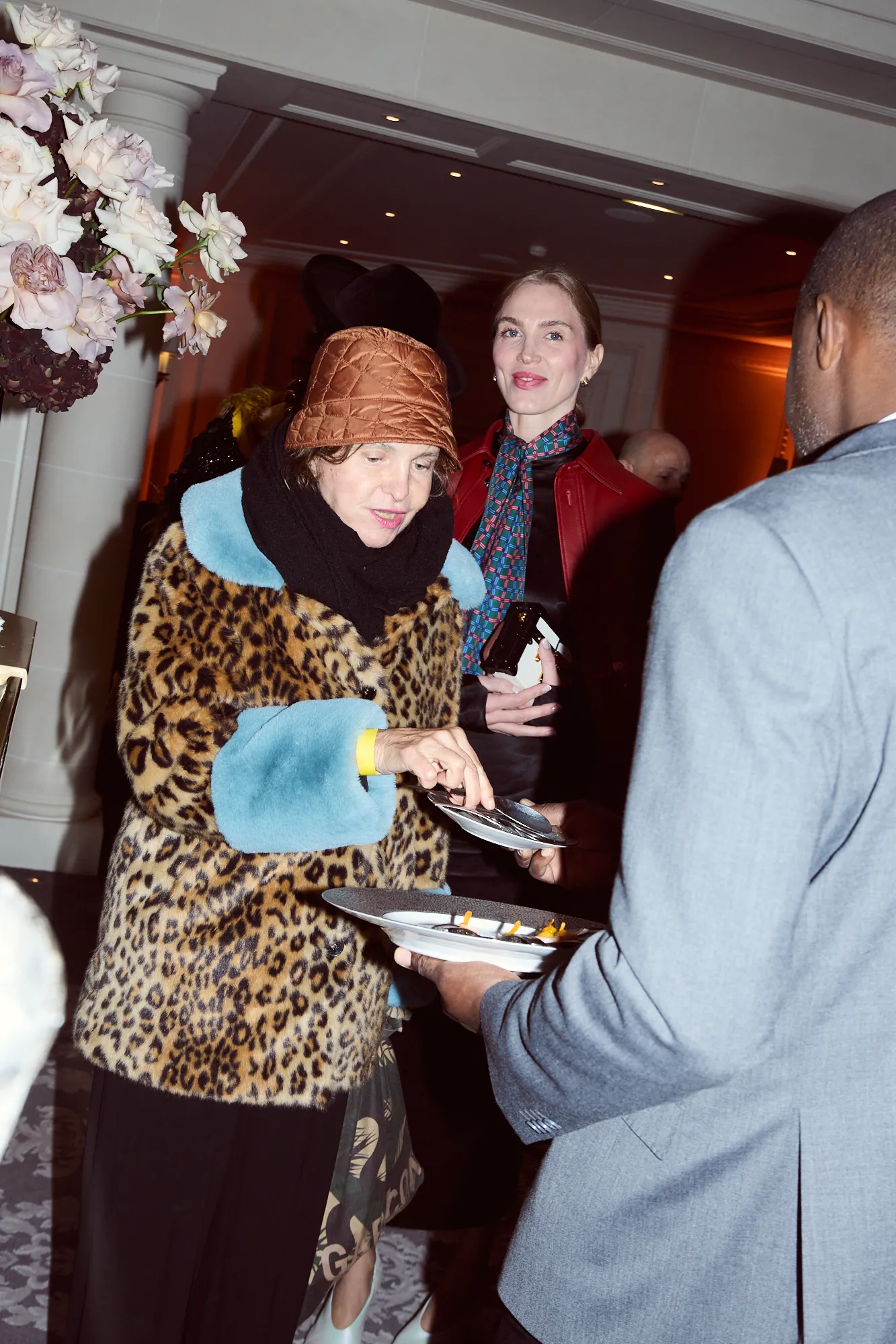 Image may contain Adult Person People Clothing Coat Jacket Face Head Photography Portrait Food Meal and Flower