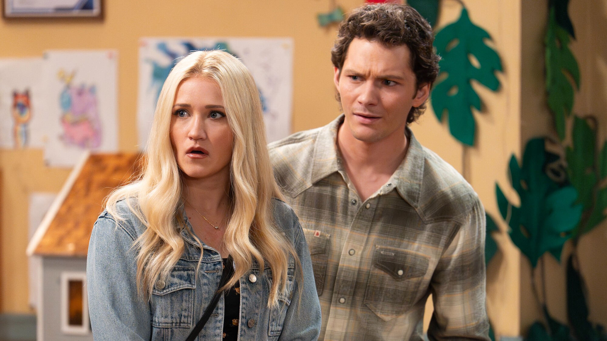 Mandy and Georgie looking shocked in Cee Cee's daycare. He's wearing a flannel shirt and she's wearing a jean jacket.