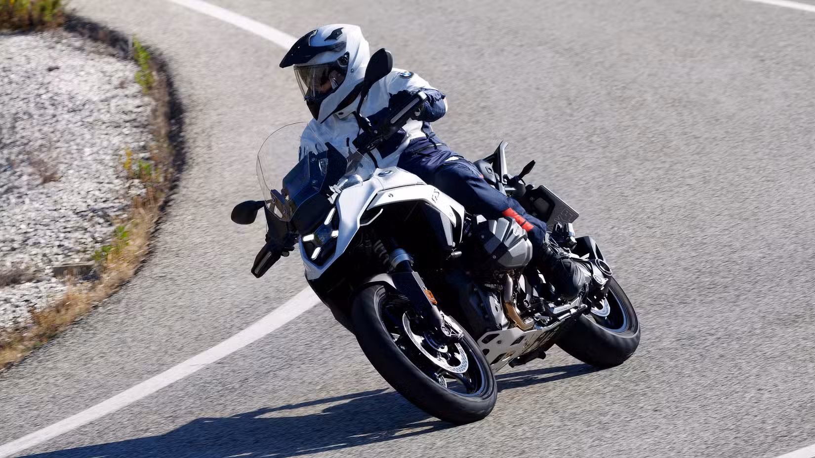 A stunning shot of a rider aboard the BMW R 1300 GS riding on a highway