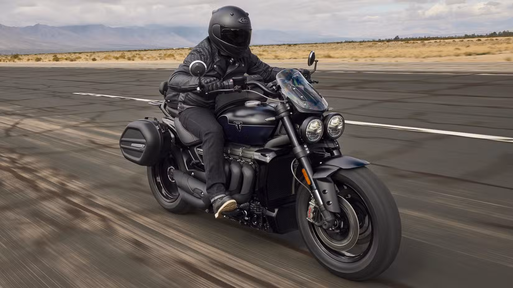 Action shot of a Triumph Rocket 3 GT with saddlebags accelerating on an airstrip