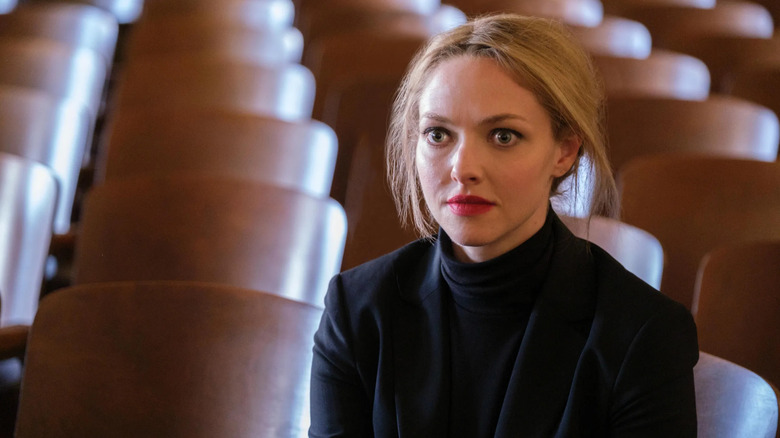Elizabeth Holmes sitting in an empty auditorium in The Dropout
