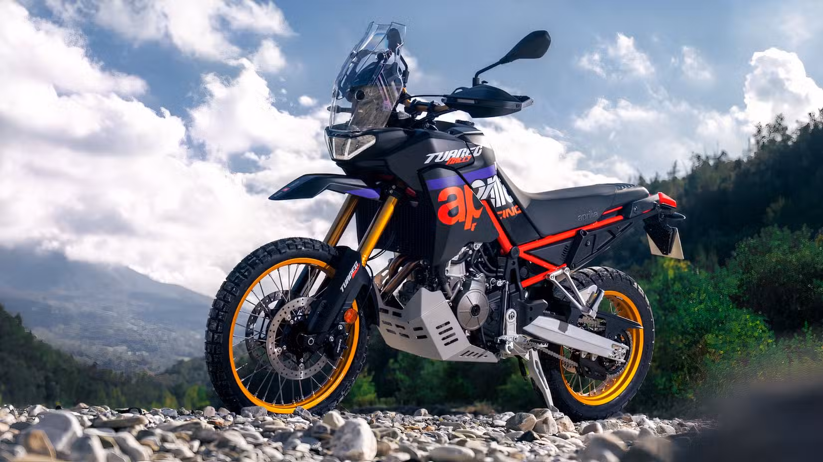 Static outdoor shot of the Aprilia Tuareg Rally 660 parked on a riverbed