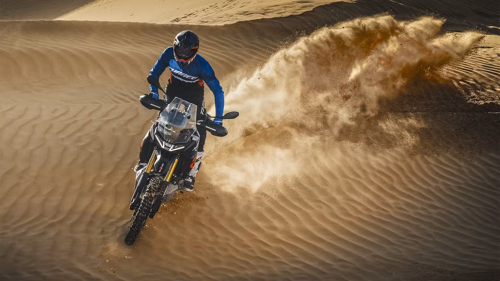 Aprilia Tuareg 660 Rally riding down a desert dune
