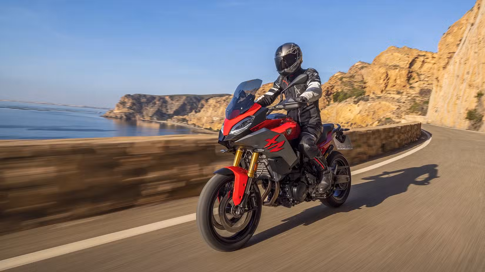 BMW F 900 XR on a scenic road front three quarter action shot
