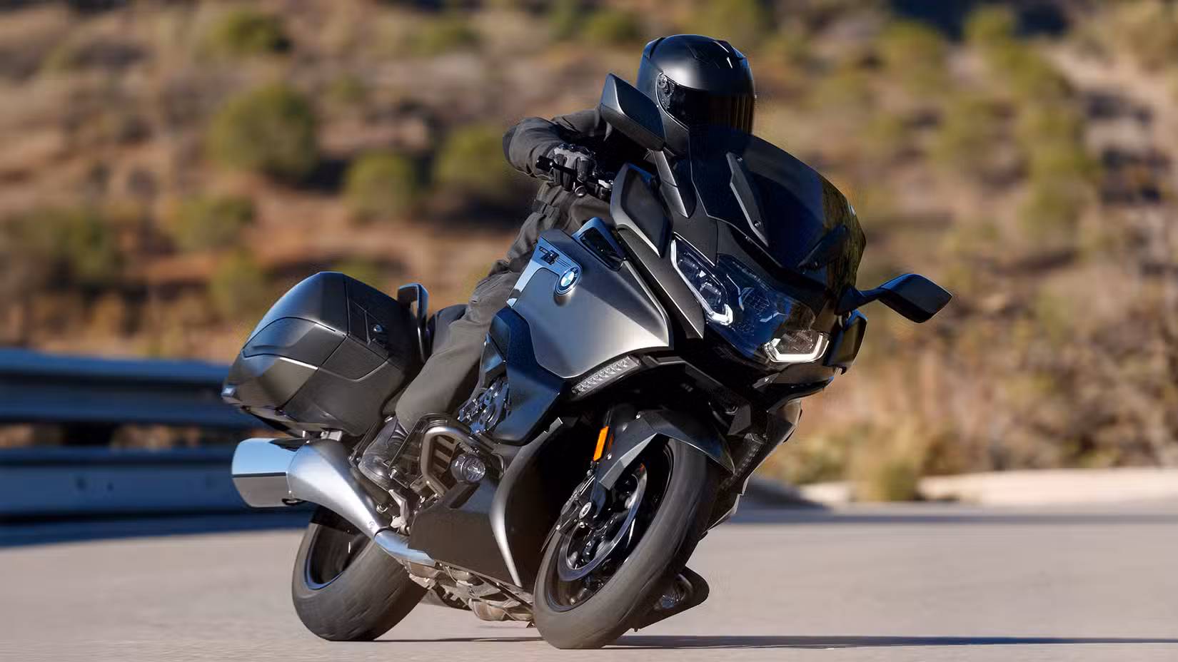 Front shot of a black BMW K 1600 B cornering on winding road