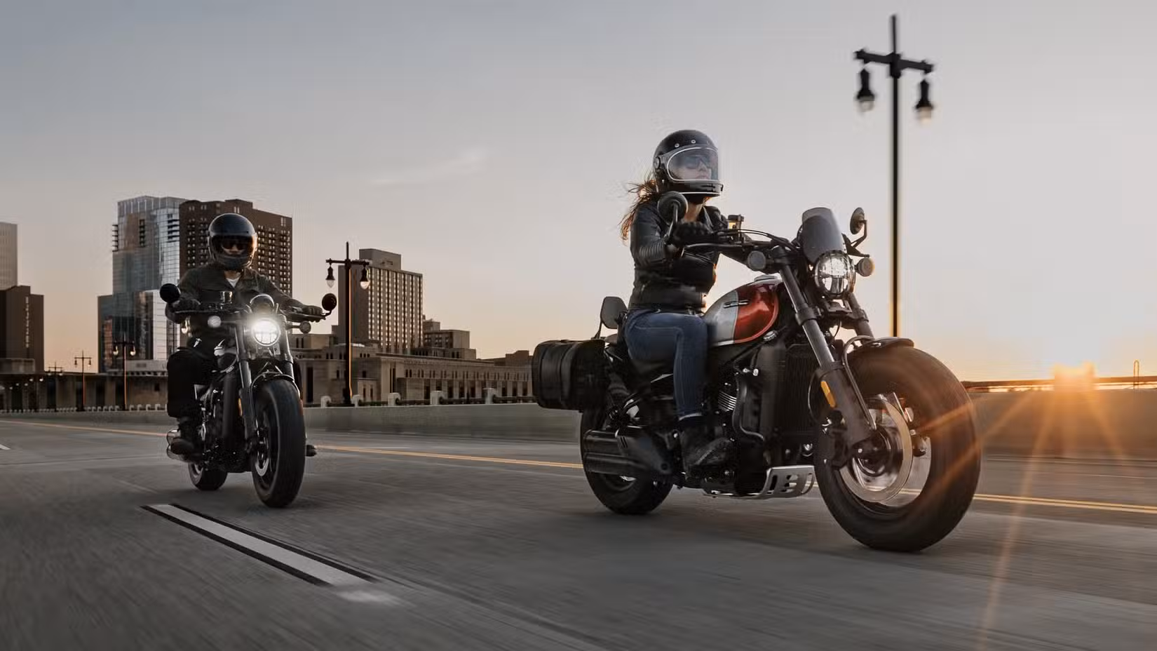 Two CFMoto 450 CL-Cs riding down a highway