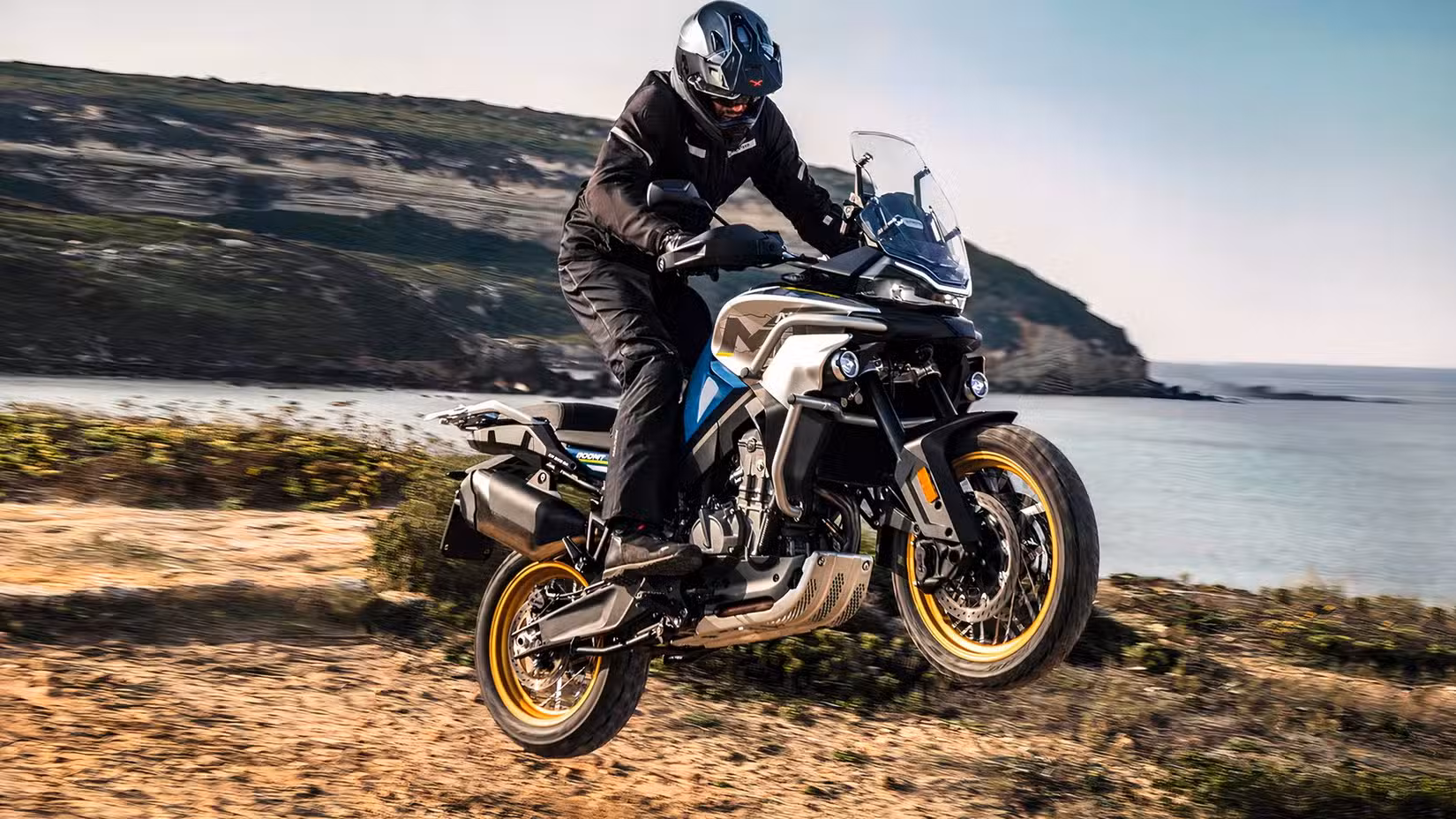 Action shot of a CFMoto Ibex 800 E riding off road 