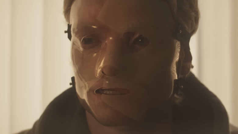 Tom Rhys Harries' Matt Hagen/Clayface is seen wearing a mask in closeup in Clayface