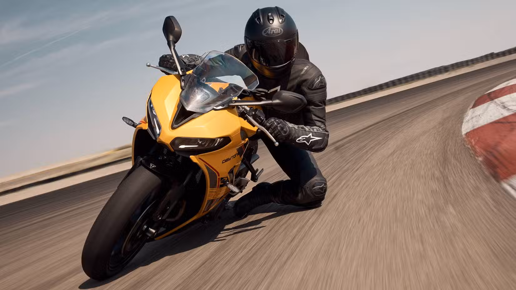 Action shot of a rider getting a knee down on a 2026 Daytona 660