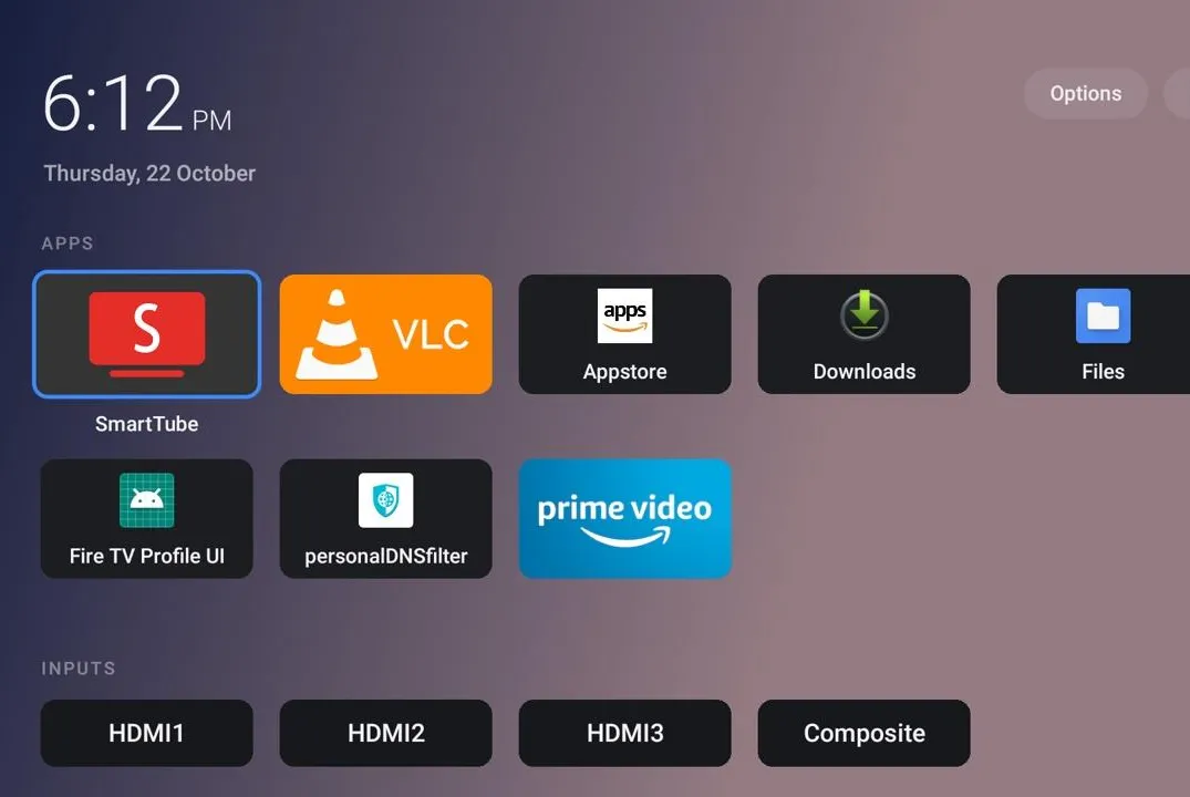 A TV operating system homescreen without ads showing app tiles and TV input connections.