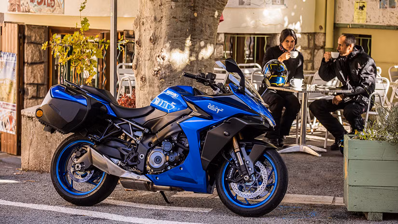 Static shot of Suzuki GSX-S1000GT+ parked outside a cafe