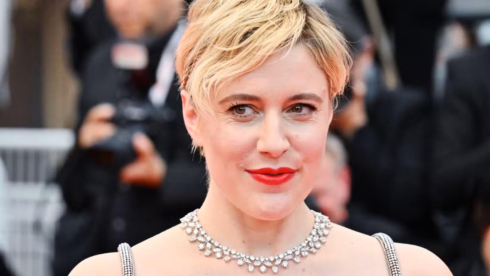 Greta Gerwig smiles on the red carpet
