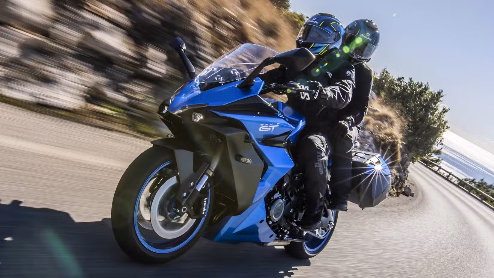 Suzuki GSX-S1000GT+ sports tourer cornering on a mountain pass