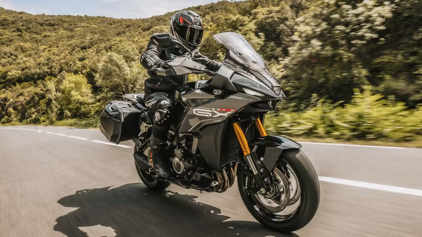 2025 Suzuki GSX-S1000GX+ accelerating front third quarter view