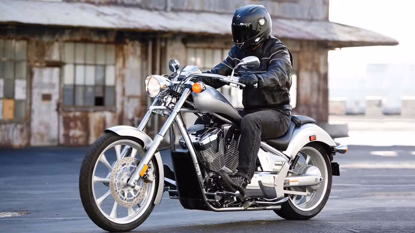 Side shot of a rider aboard a silver Honda Fury