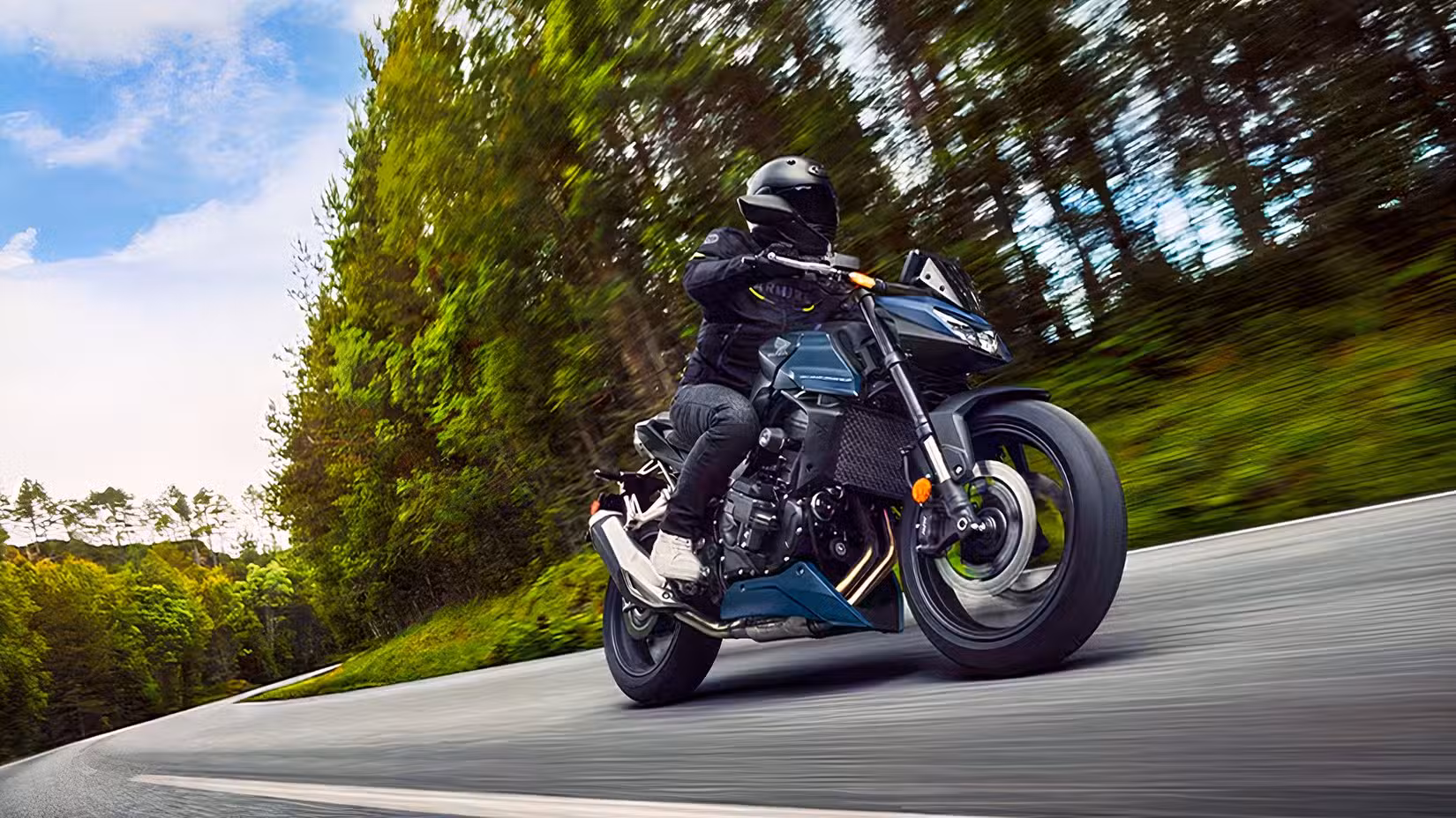 Action shot of a Honda CB750 Hornet going around a long curve