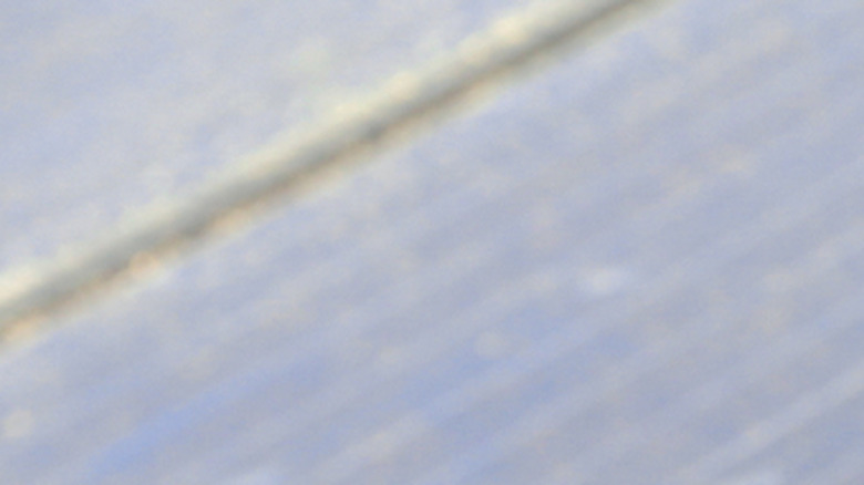 A water-fed brush cleaning the surface of a solar panel.