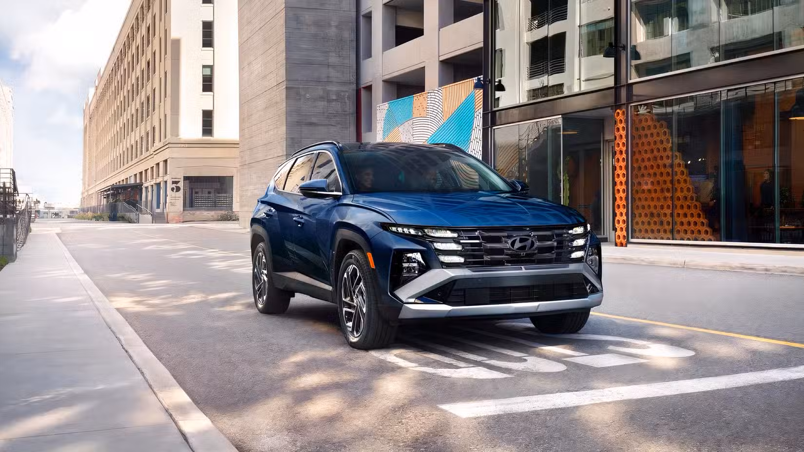 2026 Hyundai Tucson Hybrid front 3/4 shot driving in city