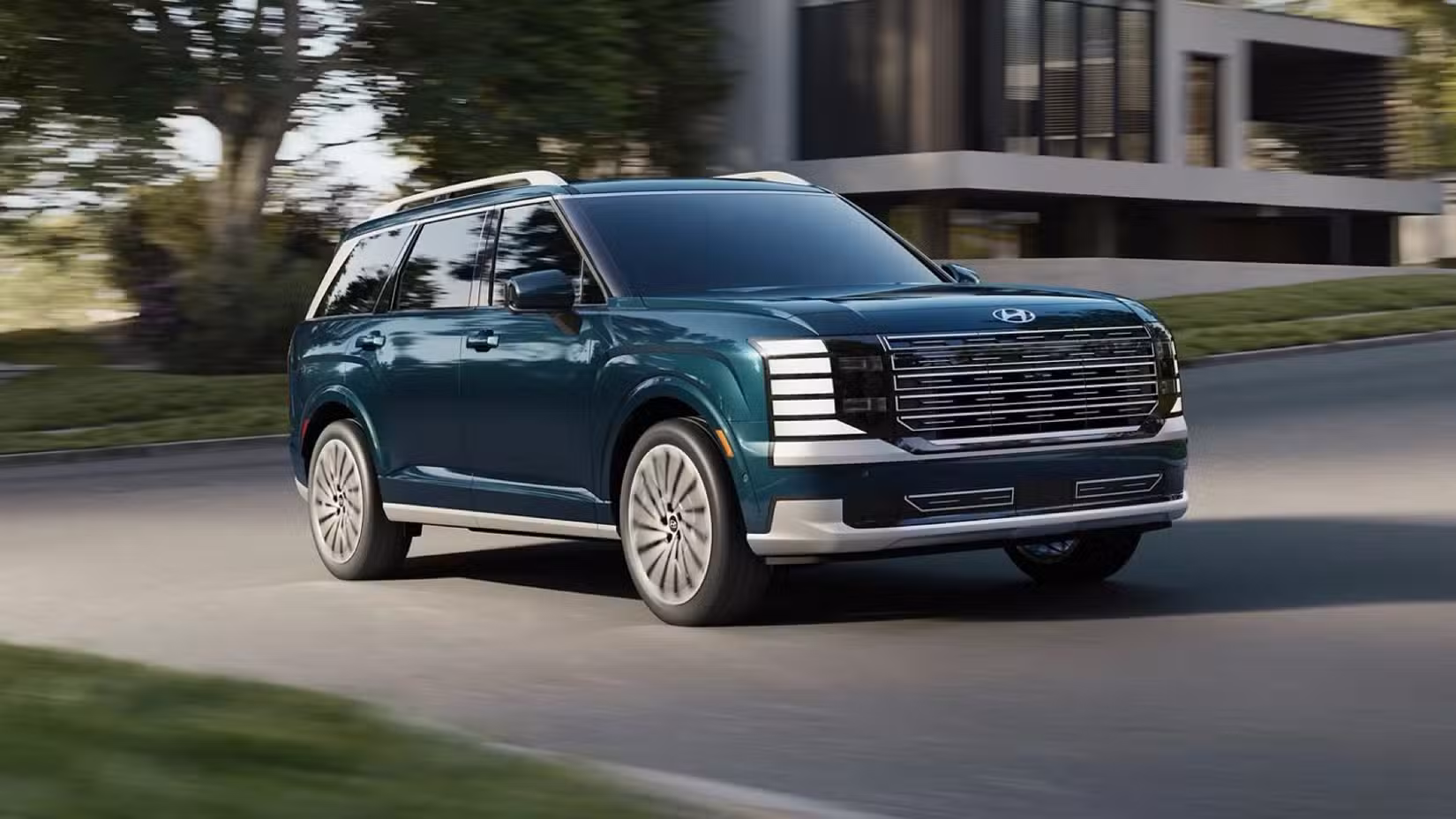 Front 3/4 action shot of 2026 Hyundai Palisade driving on road