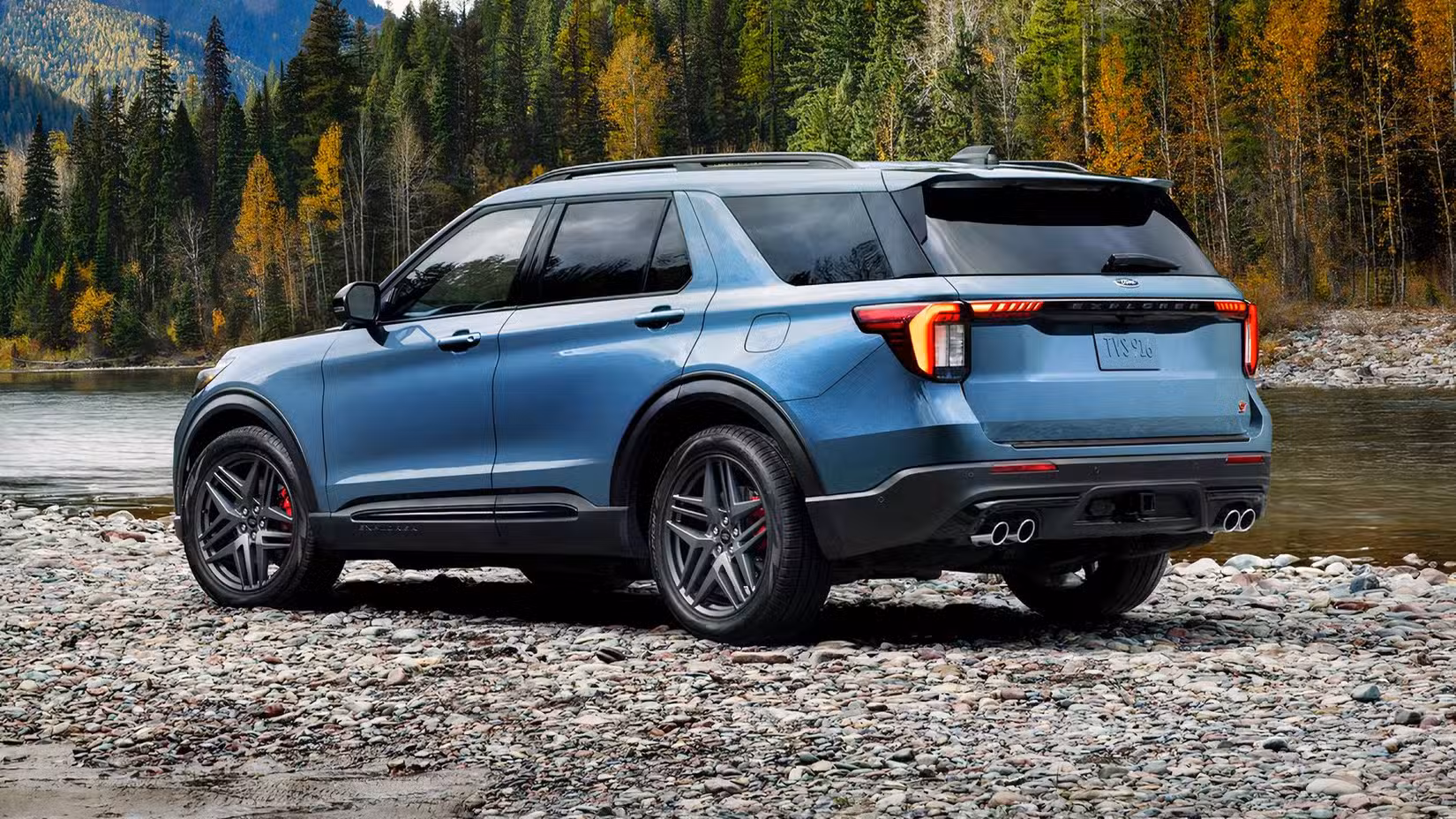 Rear 3/4 shot of 2026 Ford Explorer ST in blue parked off-road