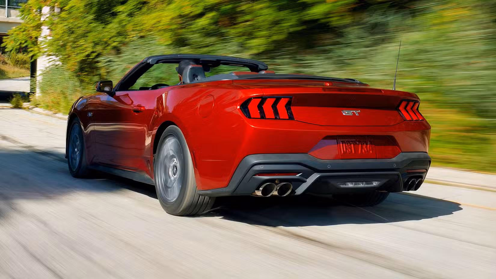 Rear 3/4 action shot of 2026 Ford Mustang GT Convertible driving