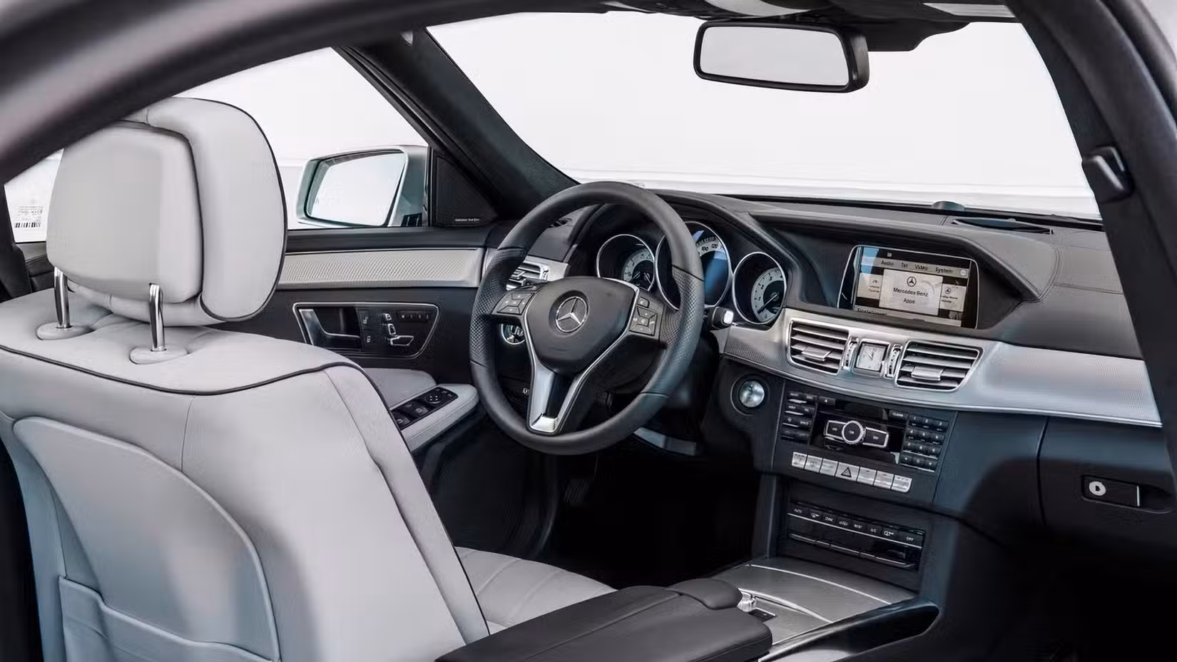 2016 Mercedes-Benz E-Class interior showing front seats and controls